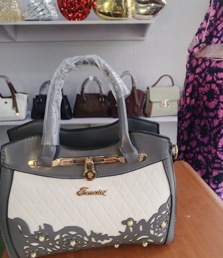 Grey satchel with gold lace-cutout detail